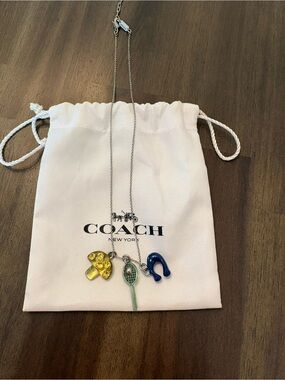 Rare Coach Mushroom, sporty tennis racquet and signature necklace.